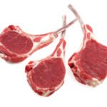 fresh lamb chops against white background