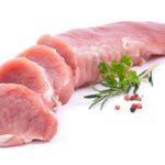 raw fillet of pork on white ground