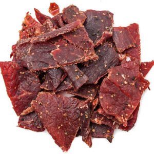heap of peppered beef jerky on white background from above